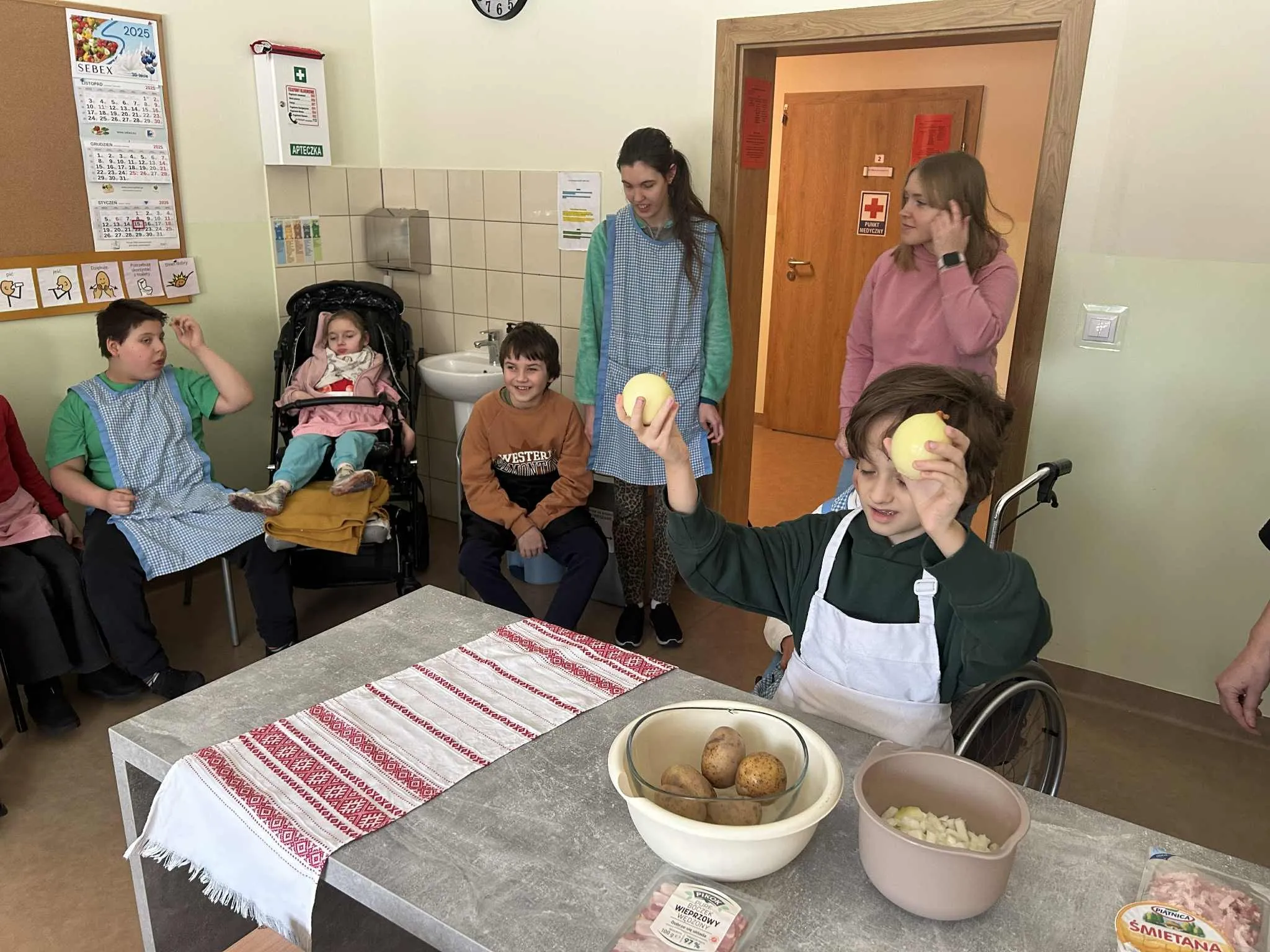 Chłopiec trzyma 2 obrane ziemniaki